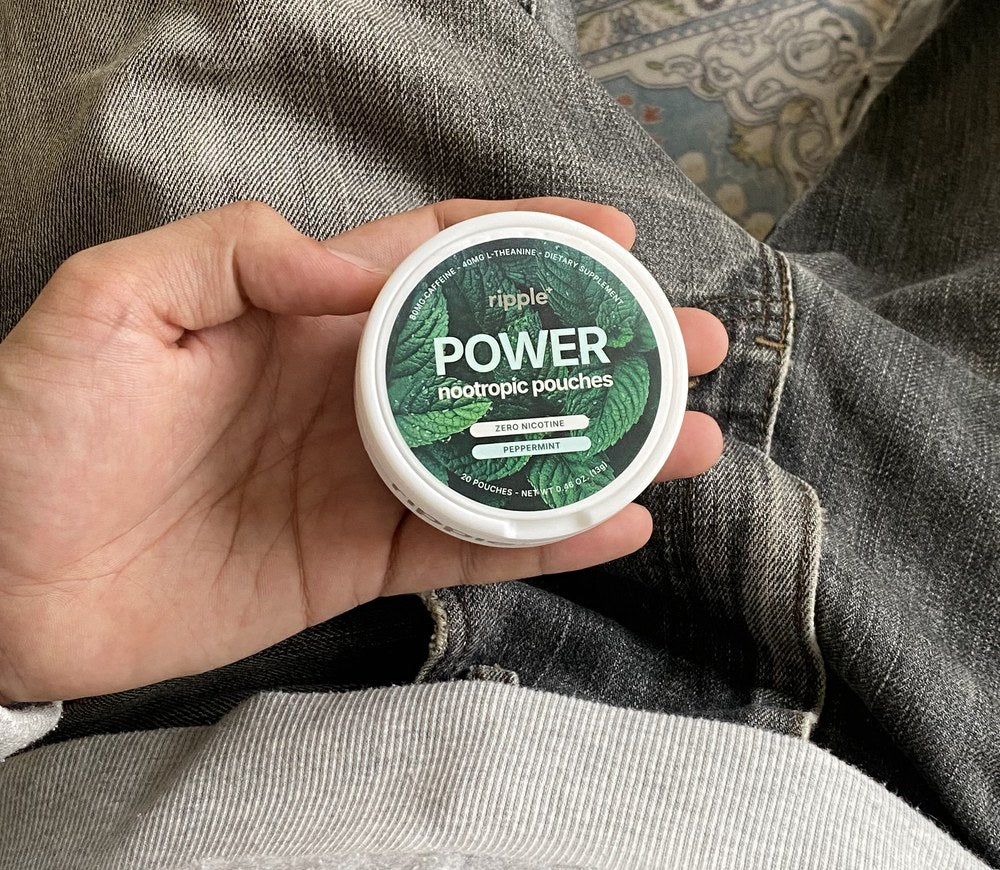 Jordan holding a Power nootropic pouch tin
