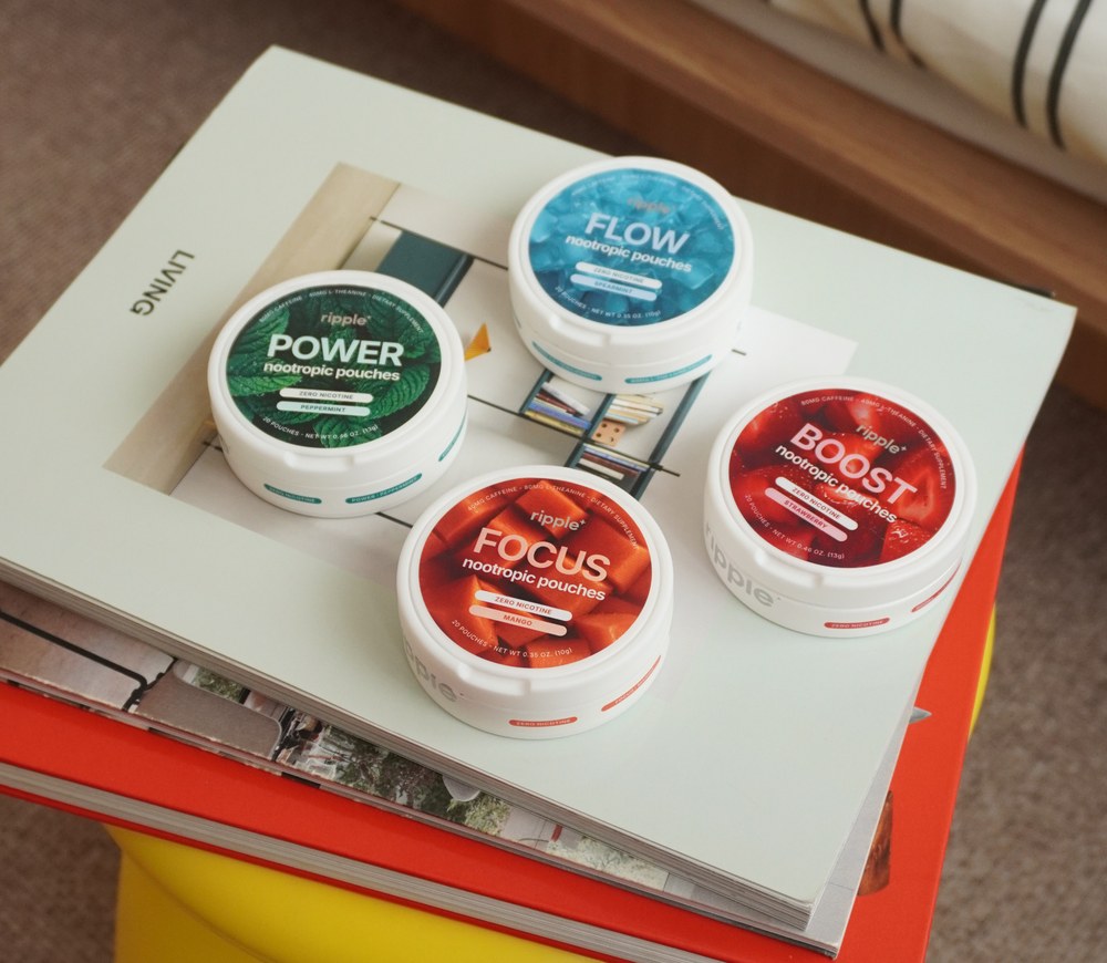 Power, Flow, Focus and Boost pouch tins on a book